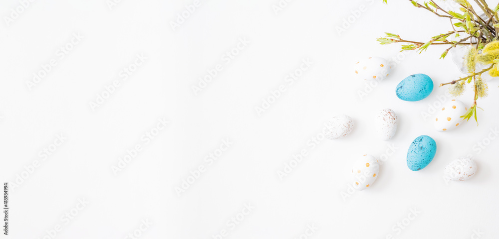 Flat lay easter composition with willow branches in a vase and easter eggs on a light background Flat lay easter composition with willow branches in a vase and easter eggs on a light background