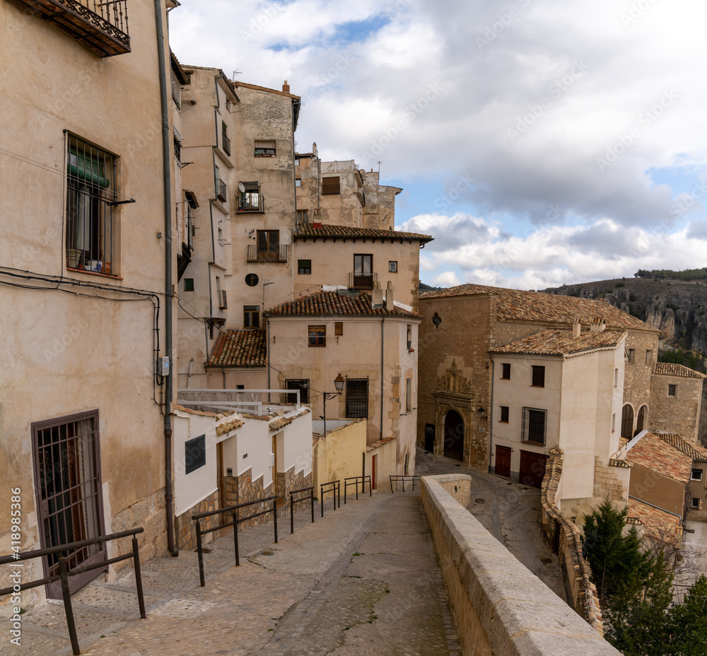 view of the old city center in Cuenca with a narrow street leading down to the Casas Colgadas or 