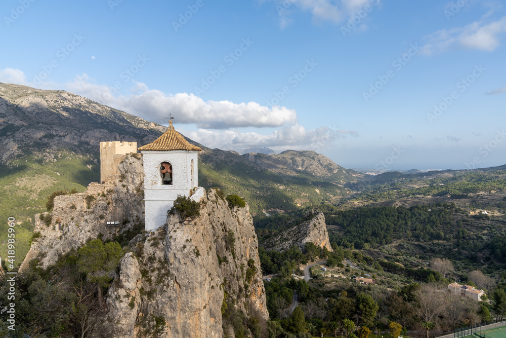 the old castle ruins and church on top of the cliffs in El Castell de Guadalest