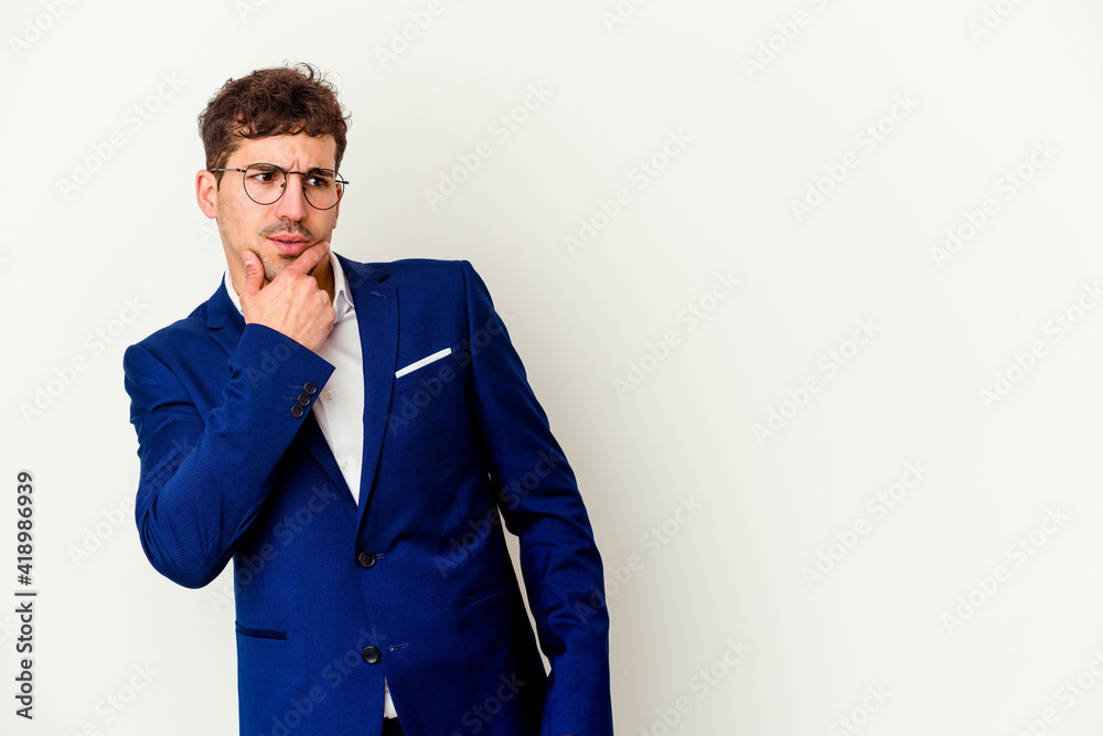 Young business caucasian man isolated on white background touching back of head, thinking and making a choice. Young business caucasian man isolated on white background touching back of head, thinking and making a choice.