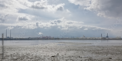 Misty view from across the water on Poolberg peninsula, with the chimneys of the power generation station, 