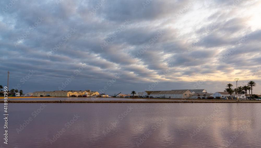Fototapeta premium industrial salt manufacturing plant and salines at San Pedro del Pinatar in Murcia at sunset