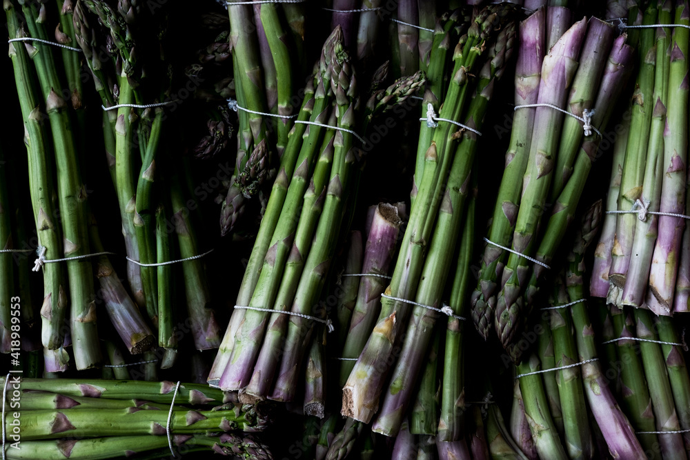 High angle close up of freshly picked bunches of green asparagus. High angle close up of freshly picked bunches of green asparagus.