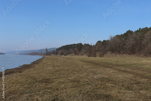 Beautiful beach with a view of a beautiful river, nearby there is a forest, a little pollution of nature