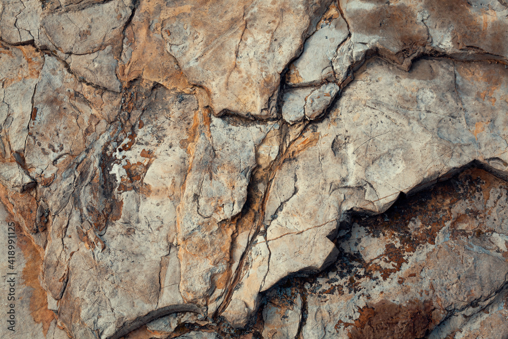 Close-up worn textured stone surface background. Rock texture detail. Geology And Mountaineering. Abstract grunge background for designers Close-up worn textured stone surface background. Rock texture detail. Geology And Mountaineering. Abstract grunge background for designers