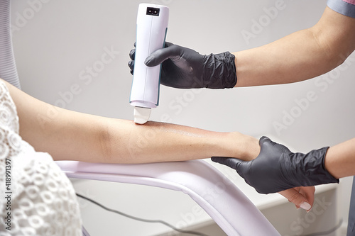 Beautiful smooth hand with hair removal close up. Concept of medicine, medical instruments, health care, beauty industry, hair removal with copy space. 
