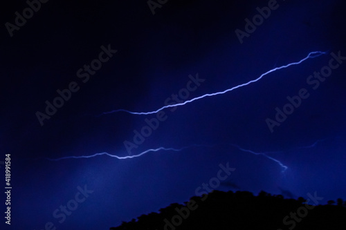 Lightning in a night sky during the thunderstorm