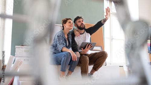 Εκτύπωση καμβά Mid adults couple planning with tablet indoors at home, relocation and diy concept
