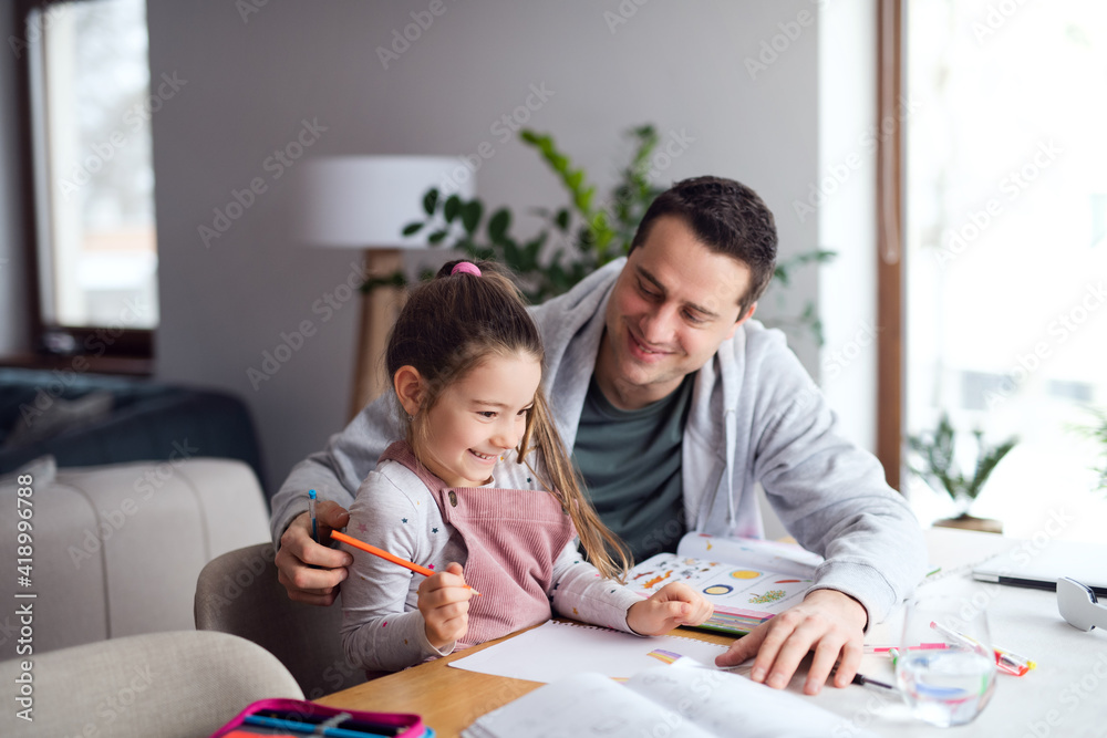 Father helping daugther with homework indoors at home, distance learning. Father helping daugther with homework indoors at home, distance learning.