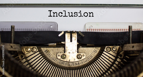 Inclusion and belonging symbol. The word 'inclusion' typed on retro typewriter. Business, inclusion and belonging concept. Beautiful background.