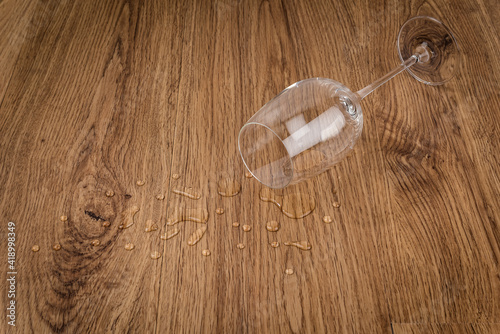 glass of water dropped on wooden floor