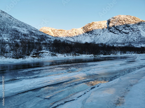 Beautiful winter landscape at the Kattfjorden, Kvaloysletta in Norway at the polar night photo