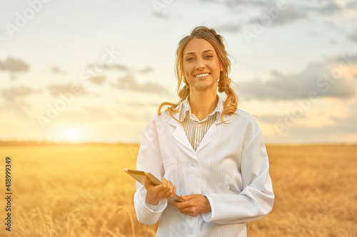 Принти на полотні Woman farmer white coat smart farming standing farmland smiling using digital ta