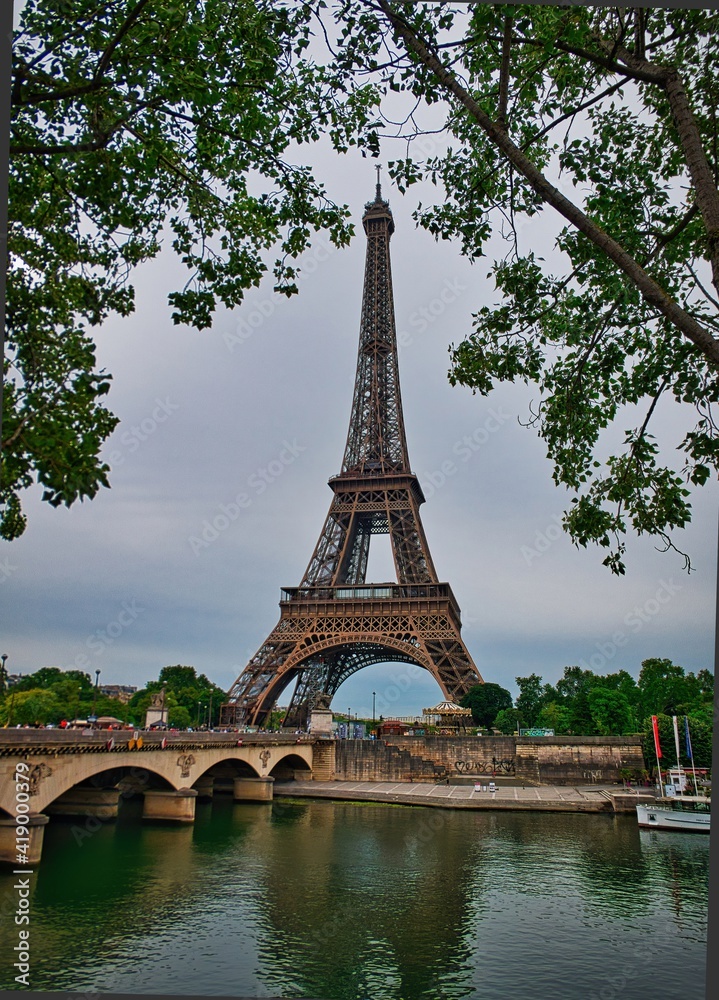 View on the famous paris eiffel tower from the promenade of the Seine .