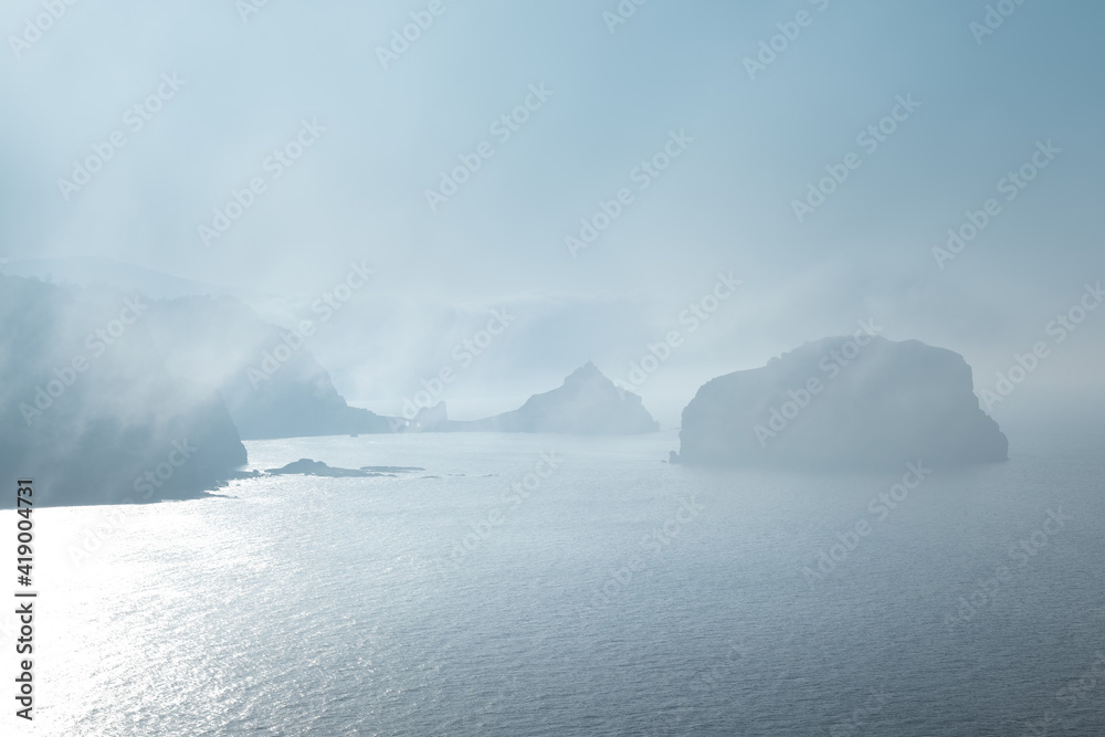 Gaztelugatxe from Machichaco Cape on a foggy day, Basque Country in Spain