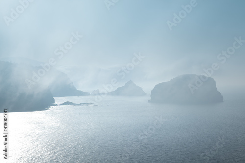 Gaztelugatxe from Machichaco Cape on a foggy day, Basque Country in Spain photo