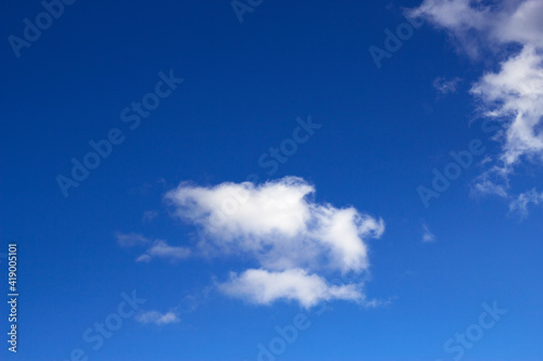 fluffy white clouds in the sky - blue vackground and abstract nature drawing as a dragon