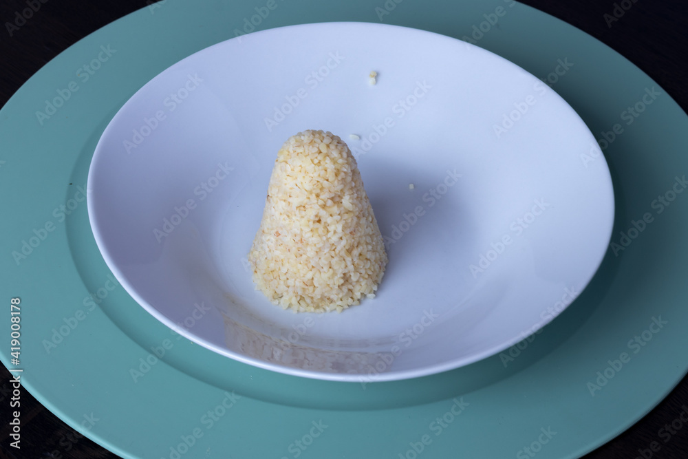 Bulgur tower on a white plate Bulgur tower on a white plate