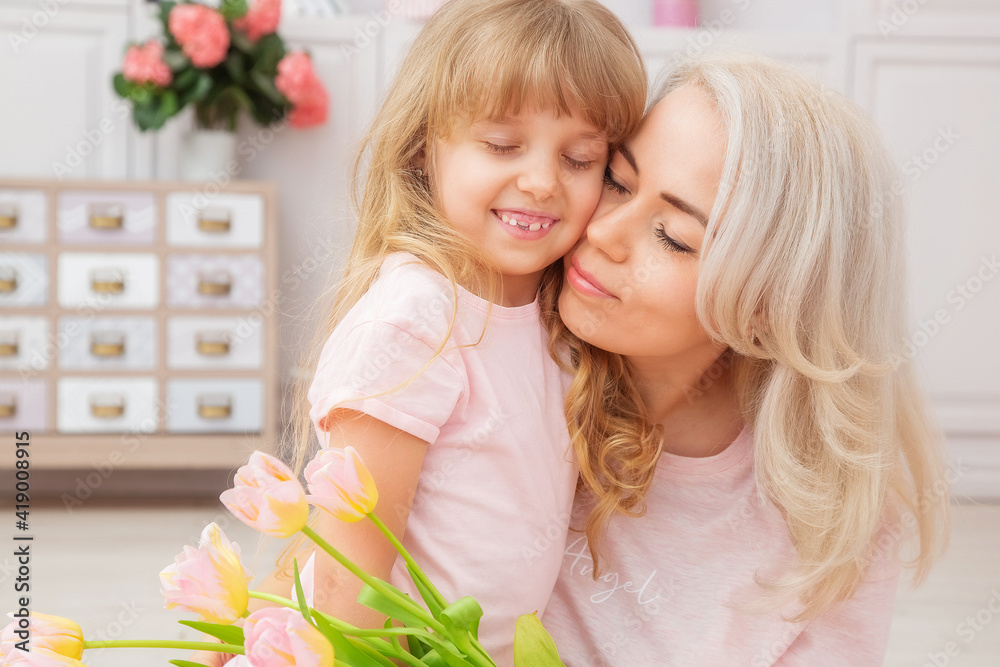 Little girl of Caucasian appearance congratulate mother on Mother's Day Little girl of Caucasian appearance congratulate mother on Mother's Day