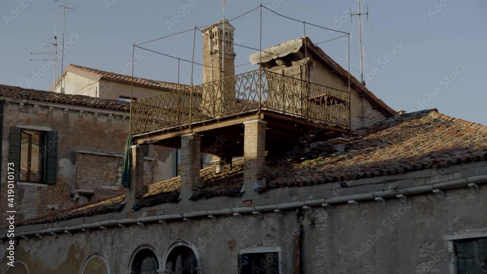 Balcony on rooftop of old townhouse in Venice, Italy.