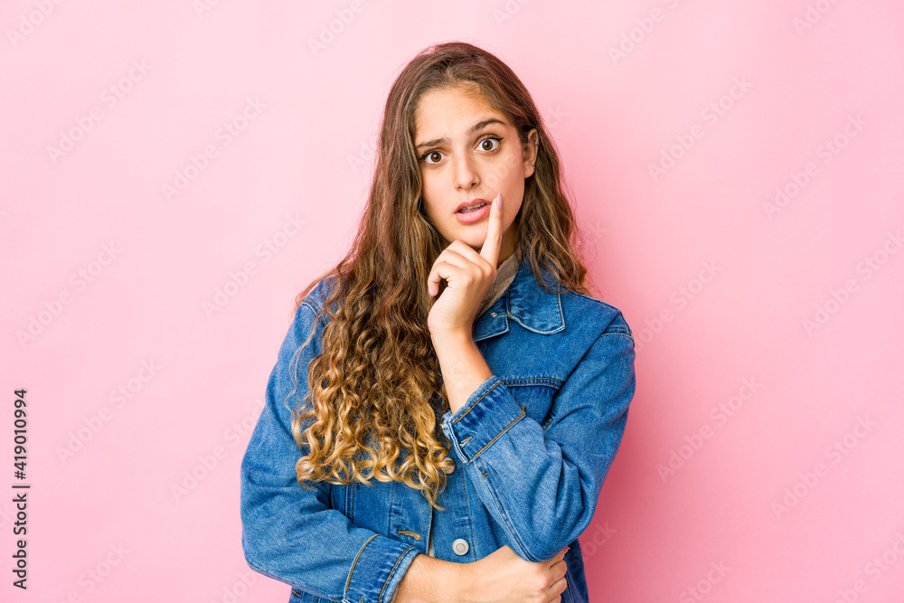 Young caucasian woman looking sideways with doubtful and skeptical expression. Young caucasian woman looking sideways with doubtful and skeptical expression.