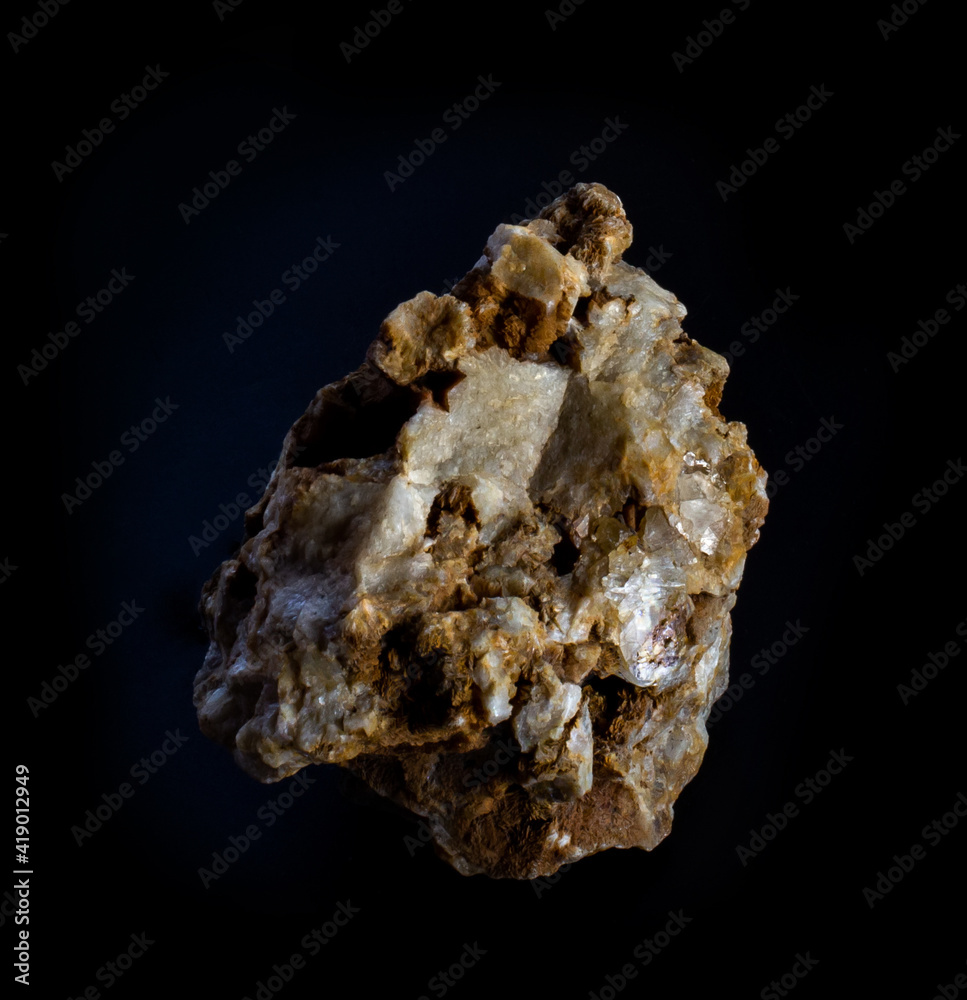 Topaz gemstone mineral crystals in rock from Volodar Volynsky, Ukraine. A photo of a stone isolated on black. Geology websites, stone collection catalog, Natural Science museum wall charts or posters Topaz gemstone mineral crystals in rock from Volodar Volynsky, Ukraine. A photo of a stone isolated on black. Geology websites, stone collection catalog, Natural Science museum wall charts or posters