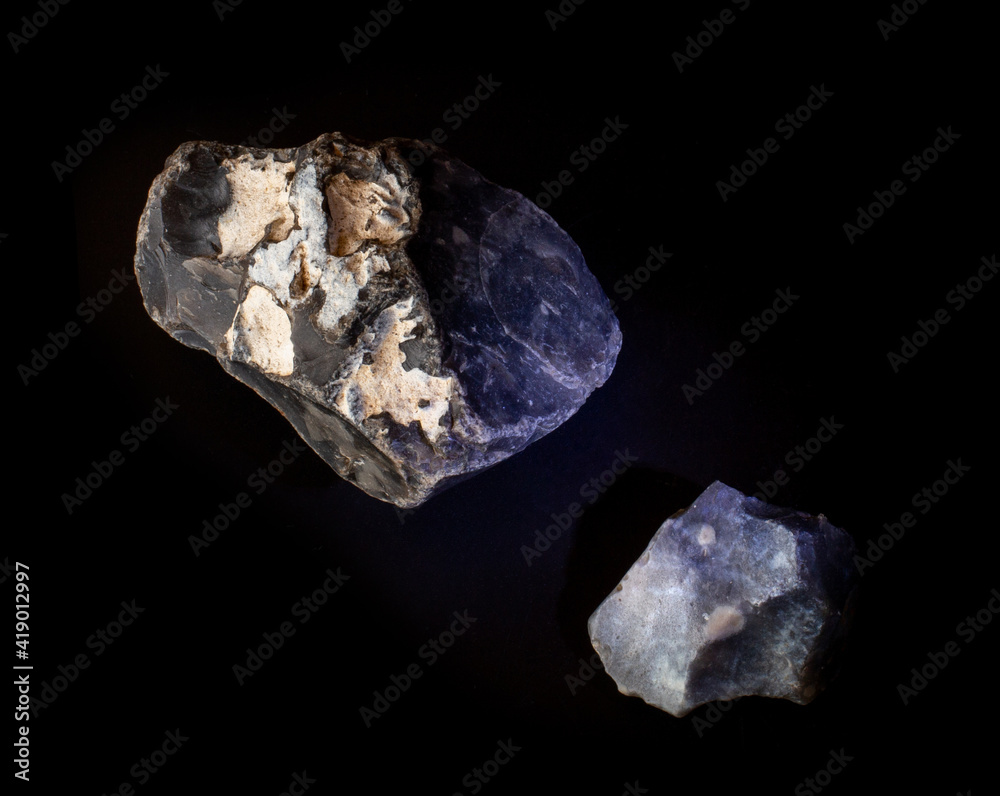 A couple of silicon mineral nuggets from Novy Volkovysk, Belarus. A photo of stones isolated on black. For Geology minerology websites, stone collection catalog, Natural Science museum wall charts