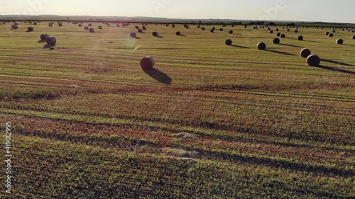 Aerial footage of a hayfield, wheat field. Rolls of haystacks on the field. Landscape with twisted haystacks in the field. Beautiful dynamic landscape drone