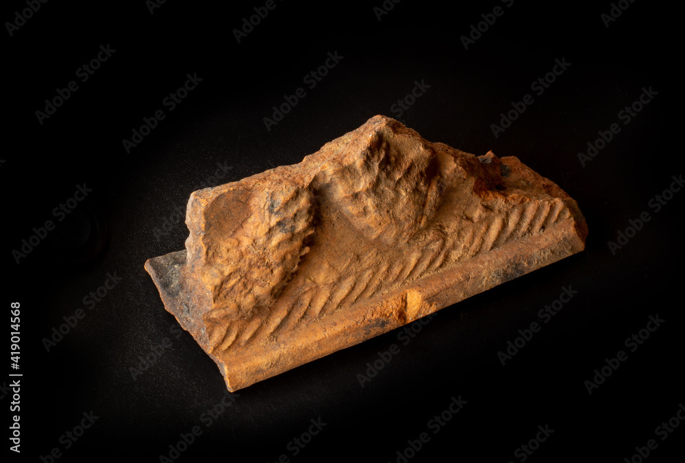 A shard of old ancient clay bowl found in Belarus. A dish crock isolated on black background. For Slavic history encyclopedia or museum wall charts, archeology website or magazine articles etc A shard of old ancient clay bowl found in Belarus. A dish crock isolated on black background. For Slavic history encyclopedia or museum wall charts, archeology website or magazine articles etc