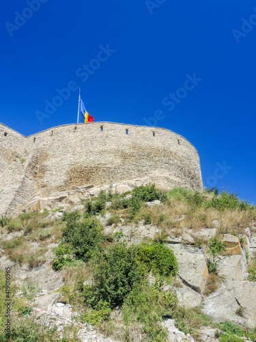 Low angle view of the Deva castle, deva city, Romania under a clear blue sky photo