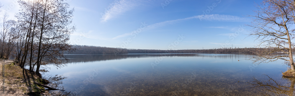 view on lake at winter time, blue sky, lake Bleibtreusee in Huerth, Germany