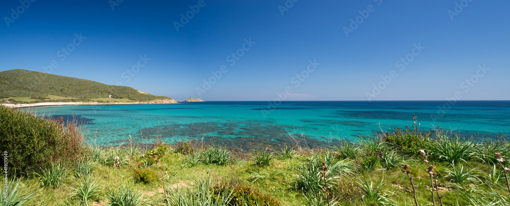 Deserted beach with turquoise and transparent sea between the 