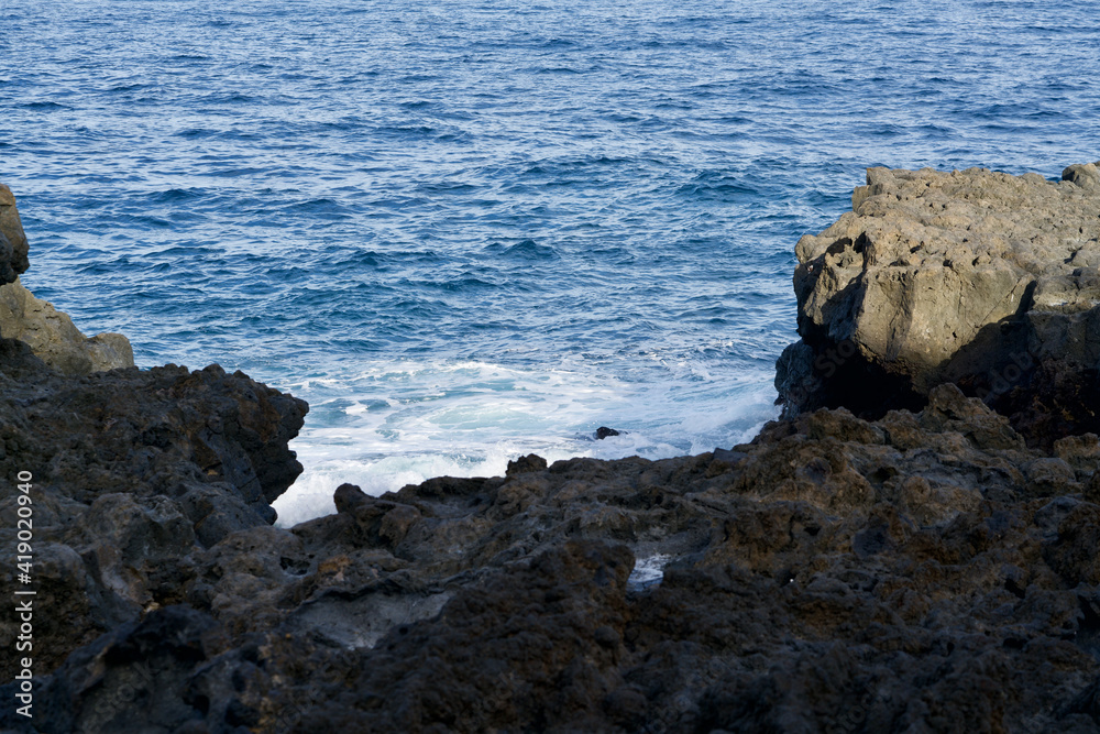 Ocean spray at a raw cliff