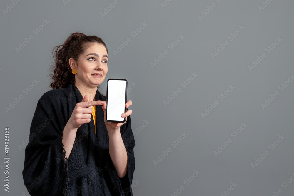 emotional young woman showing smartphone with empty touch screen with copy space emotional young woman showing smartphone with empty touch screen with copy space