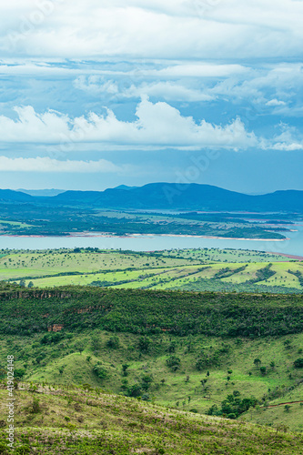 Wide panoramic view of nature beauties of Minas Gerais state. Vast green area with  a mountainous terrain and the Lake of Furnas on background. Capit  lio MG  Brazil. Mineiro eco tourism landscape.