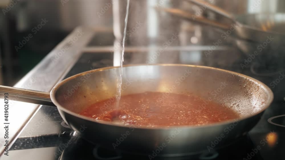 Chef cooking tasty pasta tomato sause on restaurant kitchen, traditional italian food, high kitchen cafe, man preparing dinner