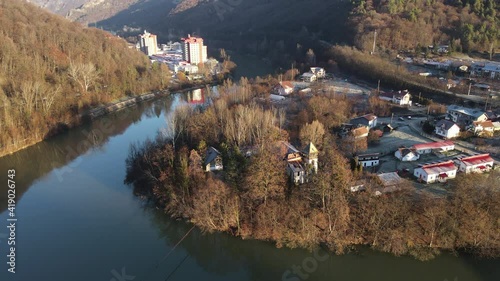 Aerial drone Caciulata Hotels in Valcea.  Cozia Monastery near Olt River bridge environment in mountain Olt Valley beautiful gorge river in Romania, defile carved valley near Cozia national park photo