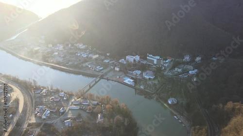 Aerial drone Caciulata in Valcea. Water streams Olt River in the Olt Valley bridge beautiful gorge river in Romania, defile carved valley near Cozia national park photo