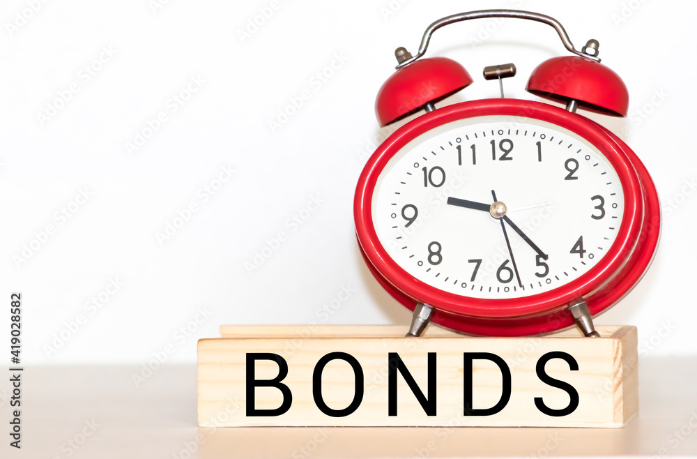 Word BONDS in wooden block on US Dollar bills Word BONDS in wooden block on US Dollar bills