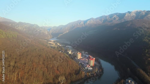 Aerial drone landscape of Calimanesti Caciulata in Valcea. Hotels near Olt River environment in mountain Olt Valley beautiful gorge river in Romania, defile carved valley near Cozia national park photo