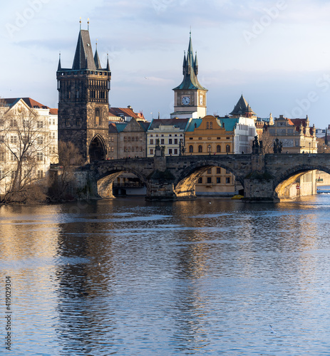 view of Charles Bridge and the Vltava River in the center of Prague before sunset