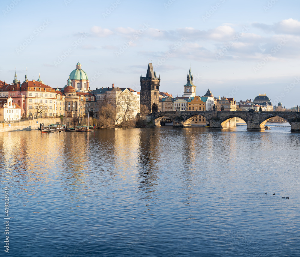 view of Charles Bridge and the Vltava River in the center of Prague before sunset
