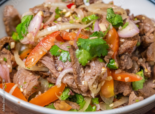 Thai dish roasted beef salad close up view. Selective focus.