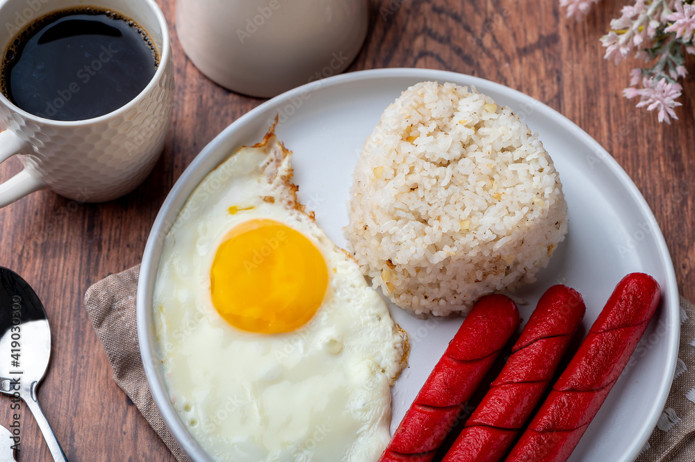 Hotsilog (top shot)- is a famous Filipino meal that consists of fried rice, egg and hotdogs. Hotsilog (top shot)- is a famous Filipino meal that consists of fried rice, egg and hotdogs.