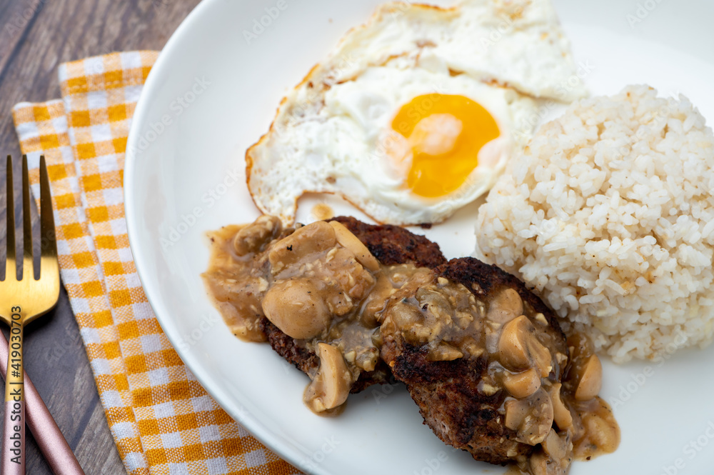 Mushroom Burger Steak Silog (side shot close up)is a famous Filipino meal that consists of