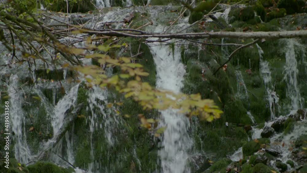 Stream flowing over mossy rocks in autumn Stream flowing over mossy rocks in autumn