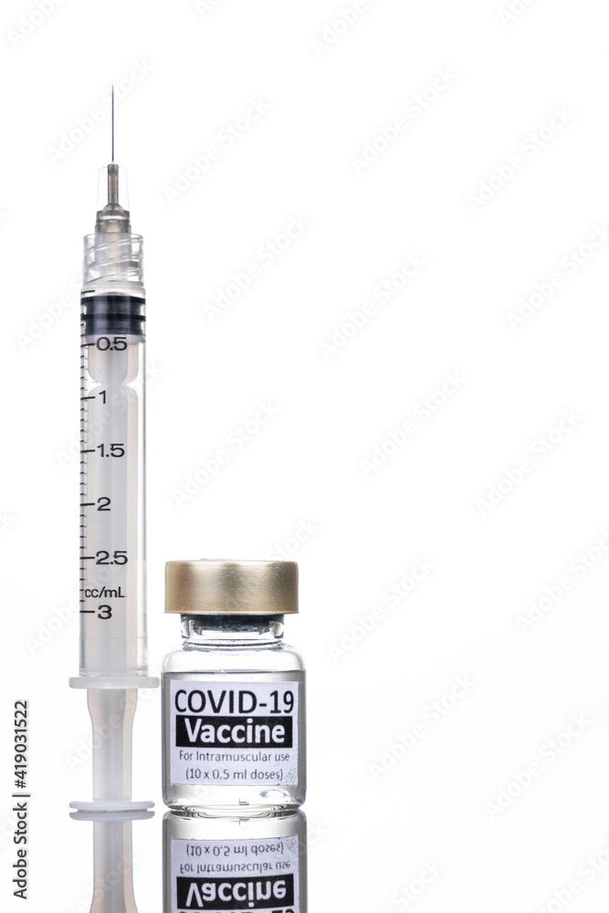 Covid-19 vaccine vial with syringe concept on reflective surface Covid-19 vaccine vial with syringe concept on reflective surface