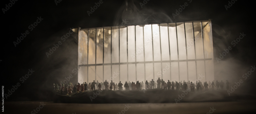 People and police government power concept. Crowd looking on big handcuffs at night with fog and backlight. Creative artwork decoration. Selective focus. - obrazy, fototapety, plakaty 