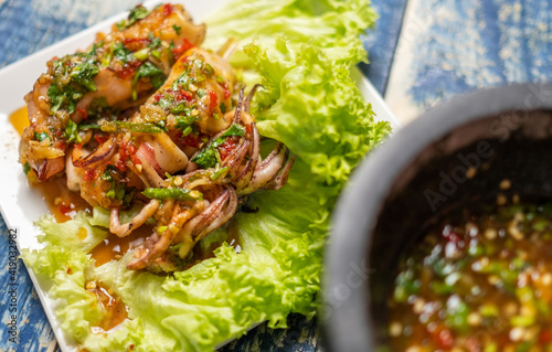 Canvas Print Malaysian dish grilled squid with spicy dipping sauce or locally known as Sotong Bakar