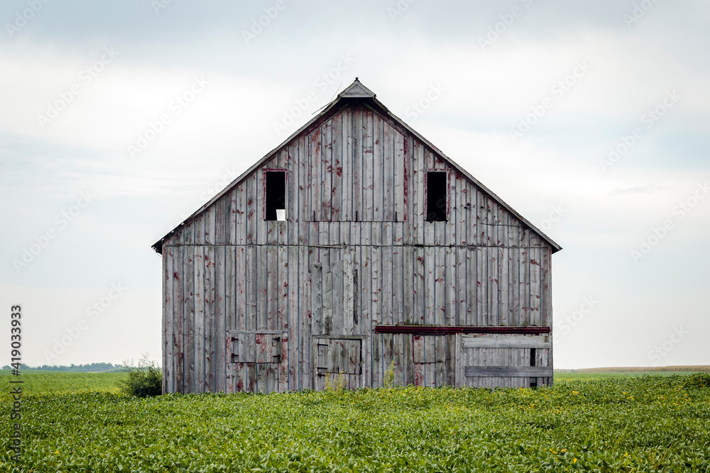 Old Barn in a Field against a Cloudy Sky Old Barn in a Field against a Cloudy Sky